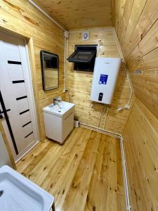 a small bathroom with a toilet and a sink at A-Frame in Dolinka