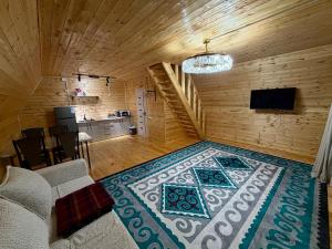 a living room with a couch and a rug at A-Frame in Dolinka