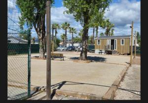 a tennis court with a fence and a bench at Bien dans le sud in Fréjus