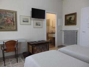 a bedroom with two beds and a table and a desk at Riflessi d'Arte in Provaglio d'Iseo