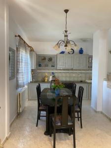 a dining room with a table and chairs in a kitchen at Valenthia in Agios Ioannis Pelio