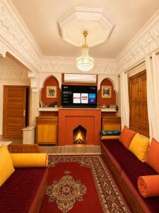 a living room with two couches and a fireplace at Villa lumina , Marrakech in Oulad Mazoug