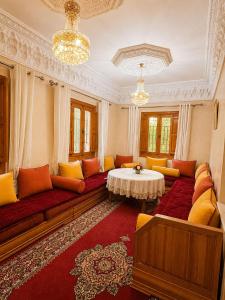 a living room with a couch and a table at Villa lumina , Marrakech in Oulad Mazoug +31 photos