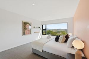 a bedroom with a large bed with a large window at Richmond Valley Luxe Escape in Richmond