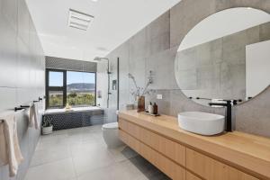 a bathroom with a sink and a toilet and a mirror at Richmond Valley Luxe Escape in Richmond +88 photos