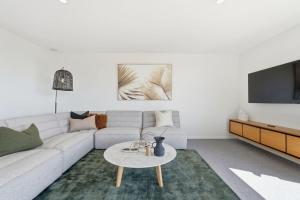 a living room with a couch and a table at Richmond Valley Luxe Escape in Richmond