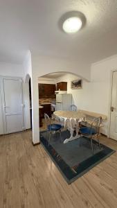 a living room with a table and chairs and a kitchen at Роман in Berehove +6 photos