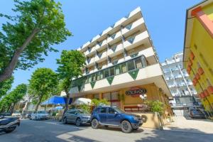 a blue truck parked in front of a building at Hotel Colorado in Rimini