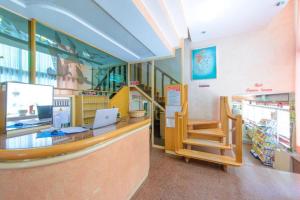 a store lobby with a counter and a staircase at Hotel Colorado in Rimini