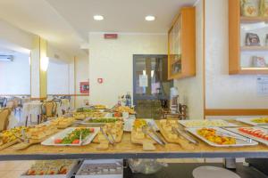 a buffet with many plates of food on a table at Hotel Colorado in Rimini