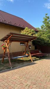 a wooden picnic table in front of a building at Роман in Berehove