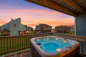a hot tub on the deck of a house at Gulf-View Townhome Hot Tub 2-Min Beach Walk in Galveston