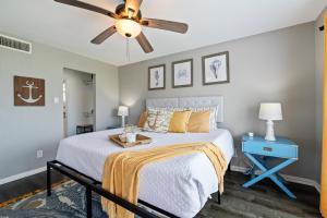a bedroom with a bed and a ceiling fan at Gulf-View Townhome Hot Tub 2-Min Beach Walk in Galveston