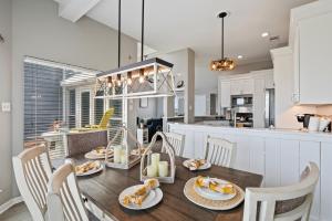 a kitchen and dining room with a table and chairs at Gulf-View Townhome Hot Tub 2-Min Beach Walk in Galveston +18 photos