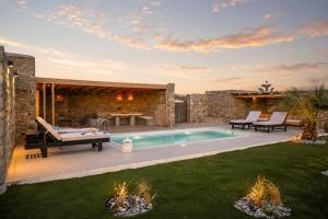 a backyard with a swimming pool and a villa at South Star private Mini Villa in Mikonos