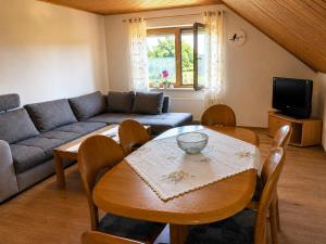 a living room with a table and a couch at Urlaub mit Hund auf dem Bauernhof Hofswald in Euscheid