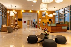 an office lobby with a reception desk and chairs at Zephyr Mazagan in El Jadida +35 photos