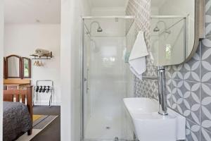 a bathroom with a shower and a toilet and a sink at Riverbend Escape, Judbury in Judbury +48 photos