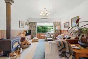a living room with a couch and a fireplace at Riverbend Escape, Judbury in Judbury