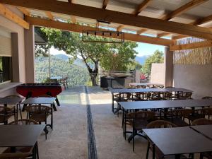 a restaurant with tables and chairs and a view at Hotel U Liccedu in Bustanico