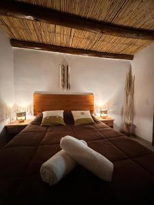 a bed with a pair of white towels on it at Luna Victoria - apart in Purmamarca