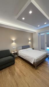 a bedroom with a bed and a couch at Villa Miranda RELAX in Ortona
