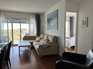 a living room with a couch and a table at Panoramic 4 Apartments 2B in Castelldefels