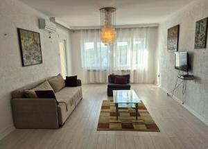a living room with a couch and a coffee table at Apartmani Božica in Jadranovo
