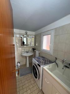 a bathroom with a washer and a sink and a washing machine at Casa Raste in Lecco +33 photos