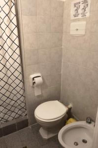 a small bathroom with a toilet and a sink at Hotel Medina y Mar BnB in Mar del Plata