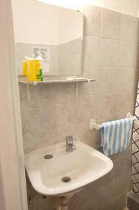 a bathroom with a white sink and a towel at Hotel Medina y Mar BnB in Mar del Plata
