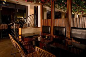 a dining room with a table and chairs and christmas decorations at Hotel La Falaise Bonapriso in Douala