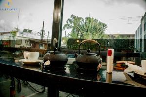 two pots and pans sitting on a kitchen counter at Hotel La Falaise Bonapriso in Douala