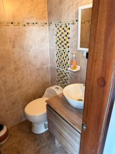 a bathroom with a toilet and a sink at Quinta San Agustin in Latacunga