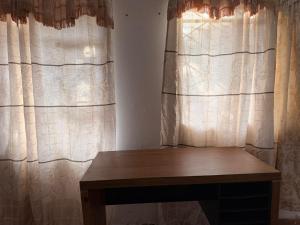 a wooden bench sitting in front of curtains at Quinta San Agustin in Latacunga