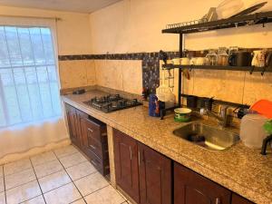 a kitchen with a sink and a stove at Quinta San Agustin in Latacunga +12 photos