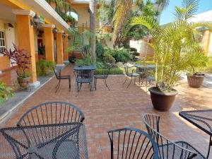 an outdoor patio with tables and chairs and plants at Hotel Mezvall in Morelia