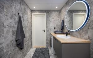 a bathroom with a sink and a mirror at Barberry Apartments in Raadi +57 photos