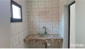 a bathroom with a sink and a shower at la perle de ngaparou in Saly Portudal