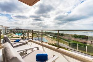 a balcony with a view of the ocean at Zephyr Mazagan in El Jadida