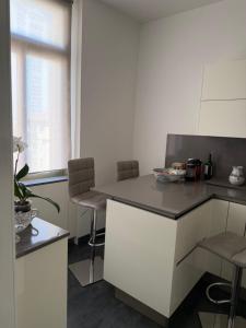 a kitchen with a counter with chairs and a table at Eden Riviera in Beausoleil