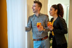 a man and a woman standing in front of a mirror at Quasi Rooms in Eger +77 photos