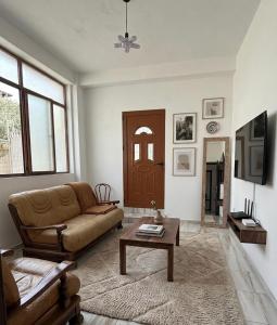 a living room with a couch and a table at Tirana Terminal Stay in Tirana