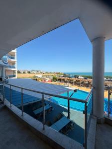 a view of a swimming pool from the balcony of a building at Aparthotel Costa Calma in Aheloy