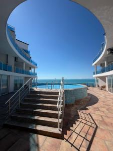 a stairway leading to a swimming pool next to a building at Aparthotel Costa Calma in Aheloy