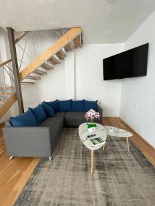 a living room with a couch and a table at Loft with Pool, Gym & A/C Suite in Querétaro