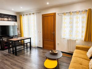 a living room with a couch and a table at Le cocondor - Design soigné et Parking facile in Montréjeau