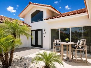 a house with a patio with a table and chairs at SWISS 42 - Golf Course in Clermont