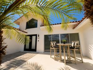a patio with chairs and a table in front of a house at SWISS 42 - Golf Course in Clermont