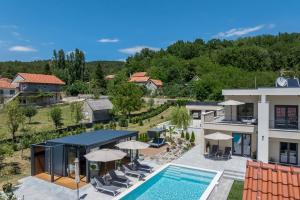 an aerial view of a villa with a swimming pool at Countryside family villa with pool Zmina in Donji Muć